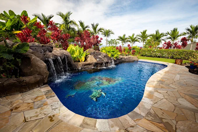 Tropical pool with lava rock waterfalls and mosaic artwork